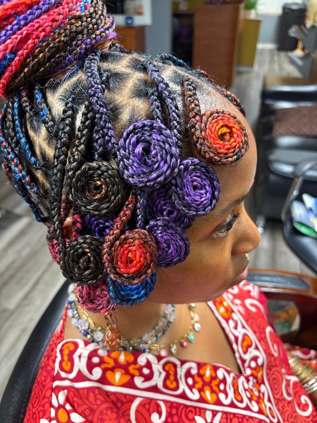 Colorful braided rosette updo by Aoua's Braids