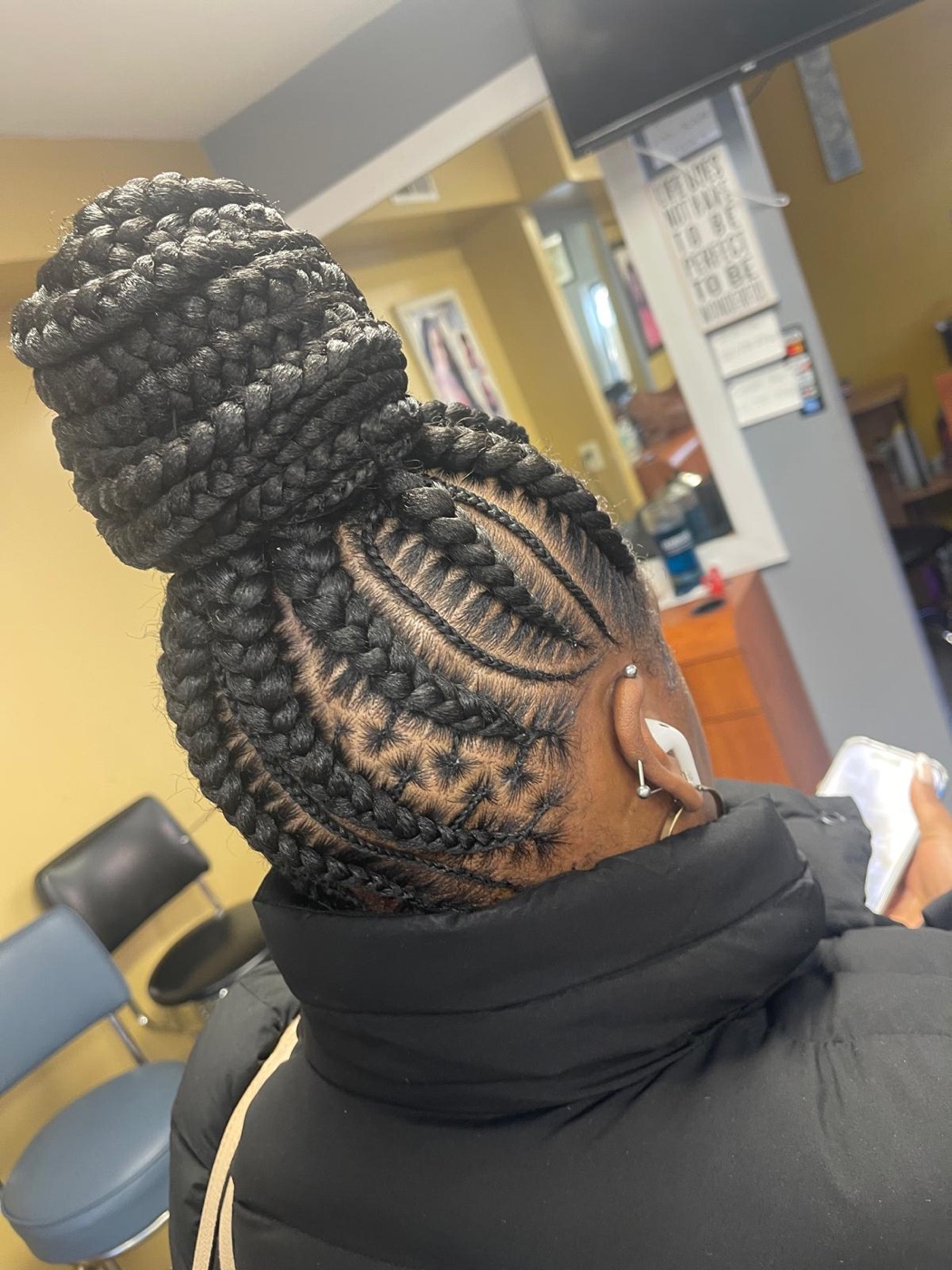 Freestyle braided bun with detailed scalp design by Aoua's Braids